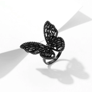 Detailed view of butterfly ring with black cubic zirconia stones on metal band