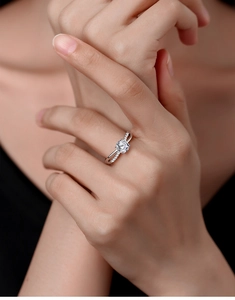 Close-up of S925 sterling silver ring with crossover shank and sparkling round solitaire moissanite