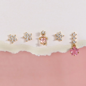 Five-piece gold stud earring set with pink zircons featuring stars and floral charms