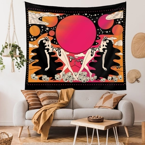 Detail of bohemian tapestry with sun, moon and celestial figures over a sofa