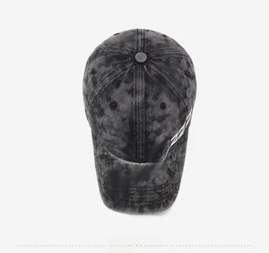 Close-up of vintage washed denim baseball cap with white ReaLuzz cursive embroidery