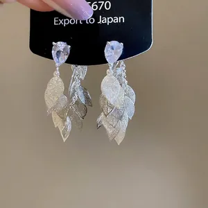 Silver hollow leaf tassel drop earrings featuring sparkling teardrop zircon stones