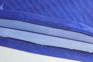 Detailed close-up of blue breathable mesh fabric with high-quality double stitching craft