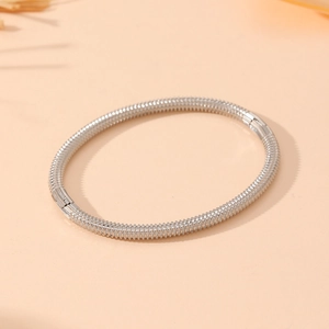 Close-up of silver stainless steel bamboo texture bangle with a secure hinge clasp