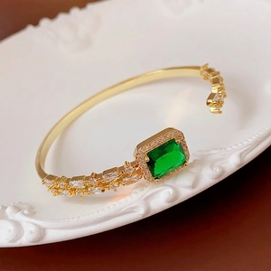 Adjustable gold bracelet with emerald green gemstone and cubic zirconia micro-pave