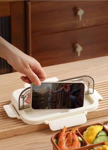 Detail view of the multi-functional lunch box lid featuring a built-in mobile phone stand