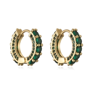Macro detail of gold hoop earrings with emerald green crystals and huggie closure