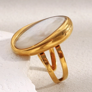 Close-up of 18K gold-plated oval white shell ring with a unique split band design