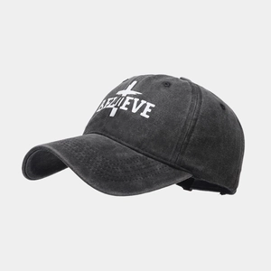Detail view of washed cotton baseball cap with Believe embroidery and cross design