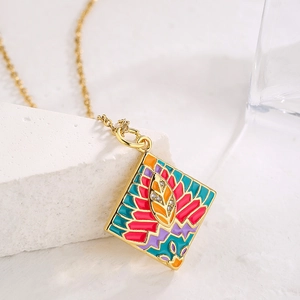 Gold plated geometric necklace with colorful enamel and zircon leaf pendant on stone