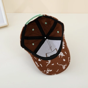 Inside detail of brown dinosaur baseball cap with green adjustable snapback closure