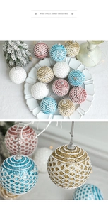 Detail of glittered Christmas balls with mesh and spiral textures on a decorative tray