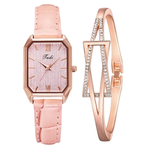 Detail of rose gold rectangular watch with pink leather strap and crystal bracelet