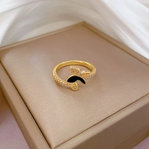 Adjustable gold butterfly ring with black enamel wings and sparkling zircon accents