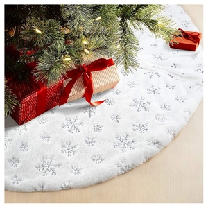 Close-up of white plush Christmas tree skirt with silver sequin snowflake patterns