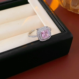 Macro view of square pink zircon crown ring with double halo pavé setting in silver