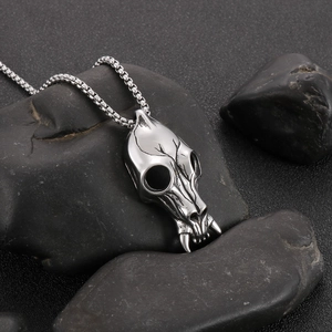 Vintage punk silver skull necklace with fangs on black stone background for men