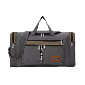 Large gray travel duffel bag with brown leather accents and multi-zipper compartments
