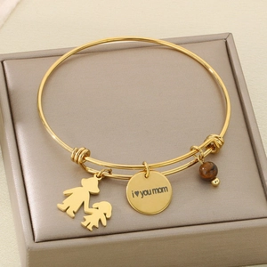 Detail of adjustable gold bangle with 'i love you mom' charm and stone bead on gift box