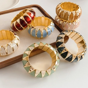 Detailed view of vintage elastic bracelets with colorful geometric resin inlays