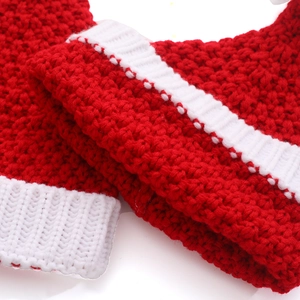 Close-up of the red and white chunky knit texture of a festive Christmas hat