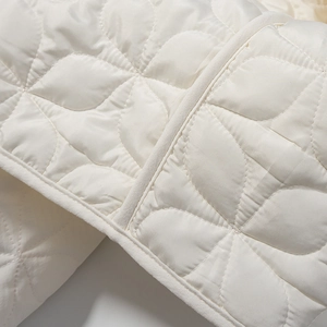 Chic quilted short jacket in cream with petal-pattern stitching and round collar detail