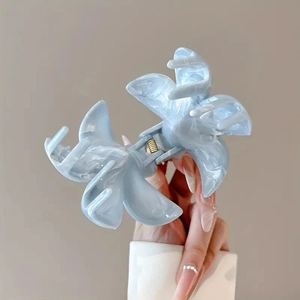 Detail of blue marble floral hair claw clip featuring non-slip teeth and metal spring