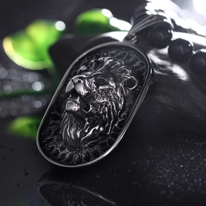 Macro shot of 3D lion head pendant with metallic luster on black beaded chain