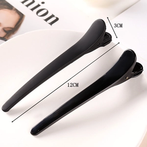 Detail showing two 12cm matte black hair claws with size dimensions for French hair styling