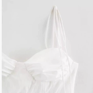 Slim fit white crop top with spaghetti straps and ruched bodice detail