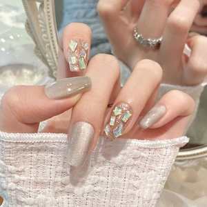 Elegant long trapezoid press-on nails with champagne gold glitter and laser diamonds