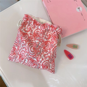 Detail of drawstring pouch with vintage red and white floral paisley oil painting pattern