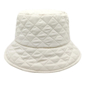 Detailed close-up of cream quilted bucket hat with padded diamond stitch texture