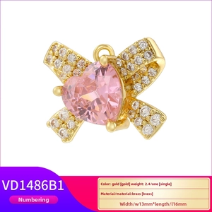 Gold plated brass pendant with a pink heart crystal and sparkling bow tie detail