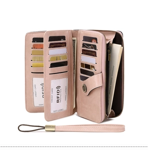 Detail of RFID protected pink leather wallet with multiple card slots and wrist strap