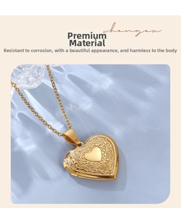 Detailed view of golden heart locket necklace with vintage floral engravings and O-chain