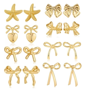 Detail view of 8 pairs of gold-plated earrings featuring starfish and bowknot designs