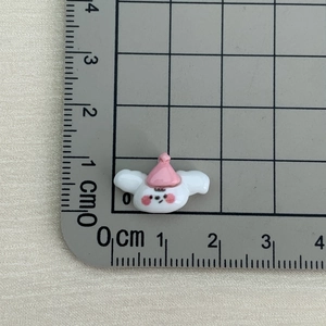 Detailed macro view showing the 1.5cm mini resin cartoon rabbit figurine size with ruler