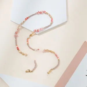 Close-up of pink stone beads and gold clasps on the handmade eyewear chain