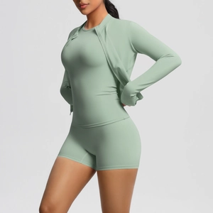 Three-piece yoga set in sage green showing zipper jacket, short sleeve top and shorts