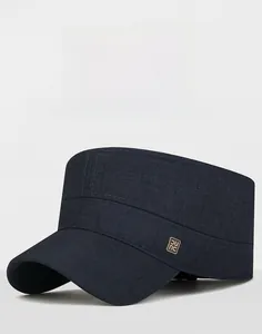 Close-up of a navy blue cadet cap with twill fabric and a side square metal badge detail