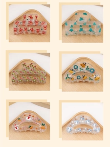 Detailed grid of transparent hair claws featuring Christmas reindeer and tree patterns