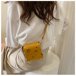 Detailed view of cheese shaped mini yellow crossbody bag with hollow hole design