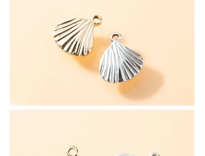 Detailed close-up of shell-shaped alloy pendants in gold and silver for DIY jewelry