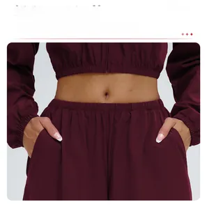 Close-up of wine red sport pants with elastic waist adjustment and side pockets details