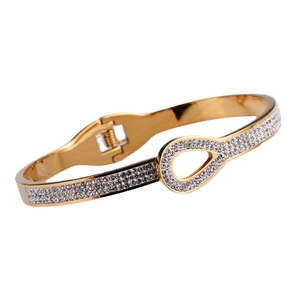 Sparkling gold open bangle with interlocking rhinestone pavé loops on white background