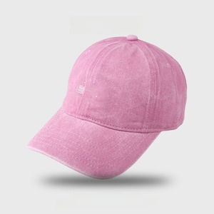 Close-up of vintage pink washed cotton baseball cap with 3D white embroidered D letter