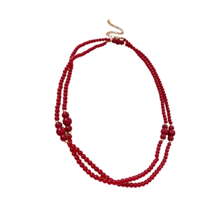 Double-layered red beaded necklace with golden lobster clasp and extension chain