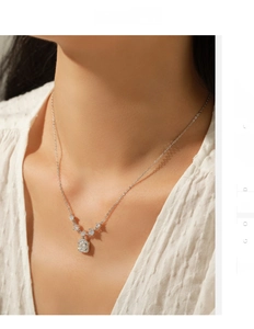 Detail of s925 silver necklace featuring a sparkling square cut moissanite pendant on neck