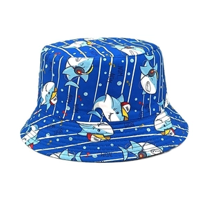 Detail of blue kids bucket hat featuring cartoon shark prints and white stripe patterns